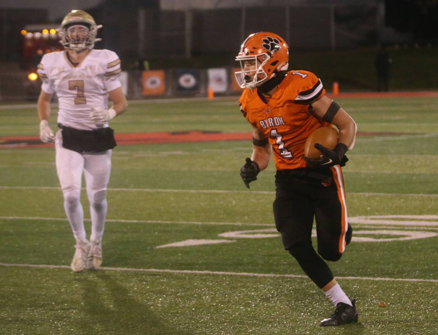 Byron's Brayden Knoll runs down the sideline to score a touchdown as Mt. Carmel's Andrew Gillihan trails behind during the Class 3A State football championship on Friday, Nov, 24, 2023 at Hancock Stadium in Normal.