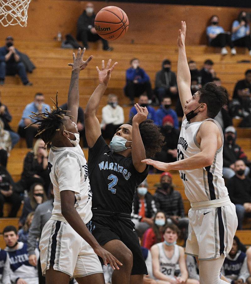 John Starks/jstarks@dailyherald.com
Willowbrook’s Alex Simmons splits the defense of Addison Trail’s Amarie Stewart, left, and Jacob Daniels in a boys basketball game in Addison on Tuesday, January 18, 2022.