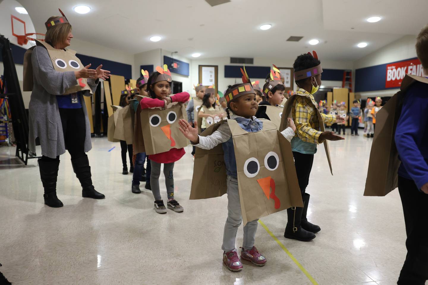 Kamea Guzman, front, leads Laura Bryll’s class in a dance during a Thanksgiving gathering at Thomas Jefferson Elementary School in Joliet on Friday.