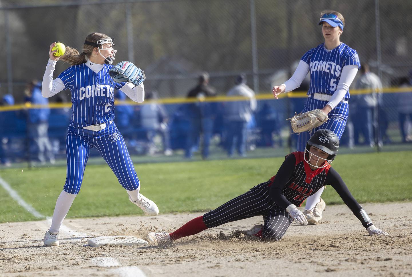 Newman’s Brenleigh Cook looks to throw after making an out at third base against Hall last season.