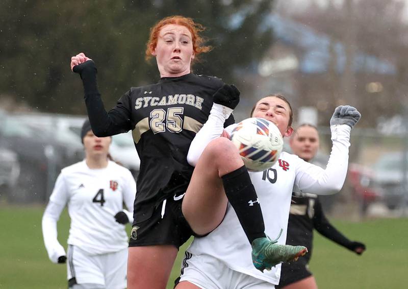 Sycamore's Izzie Segreti and La Salle-Peru's Kendal Bassett go up for a ball during their game Wednesday, April 9, 2025, at Sycamore High School.