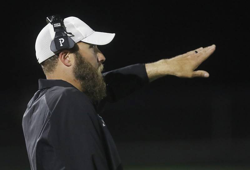 Woodstock North Head Coach Jeremiah Homuth directs his defense during a Kishwaukee River Conference football game against Johnsburg on Friday, Sept. 26, 2025, at Johnsburg High School.
