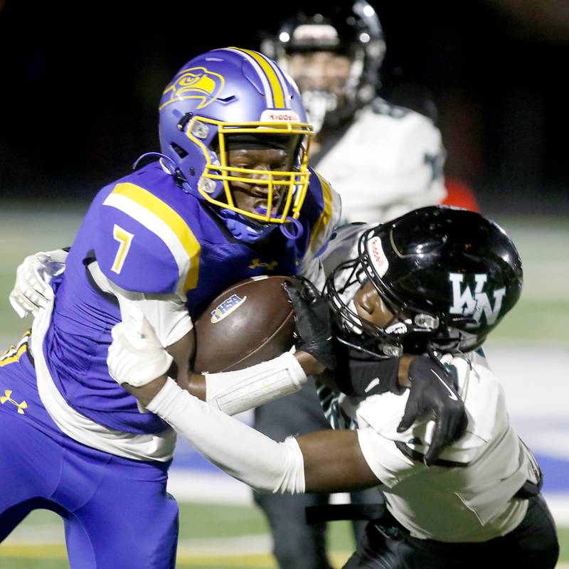 Johnsburg's Jarrel Albea is tackled by Woodstock North's Jr Fadahunsi during a Kishwaukee River Conference football game on Friday, Sept. 26, 2025, at Johnsburg High School.