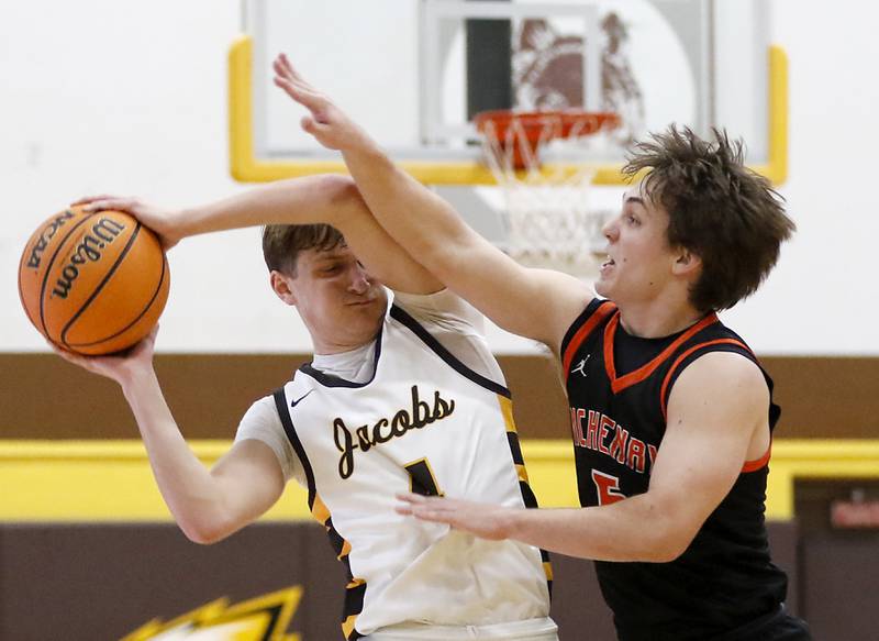 Jacobs' Ben Jurzak is pressured by McHenry's Kyle Maness during a Fox Valley Conference basketball game on Friday, Jan. 24, 2025, at Jacobs' High School..