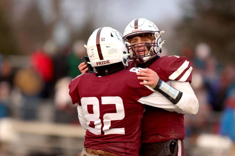 Prairie Ridge’s Tyler Vasey, right, congratulates teammate Brogan Amherdt after Amherdt’s field goal clinched a win over St. Ignatius in Class 6A football playoff semifinal action at Crystal Lake on Saturday.