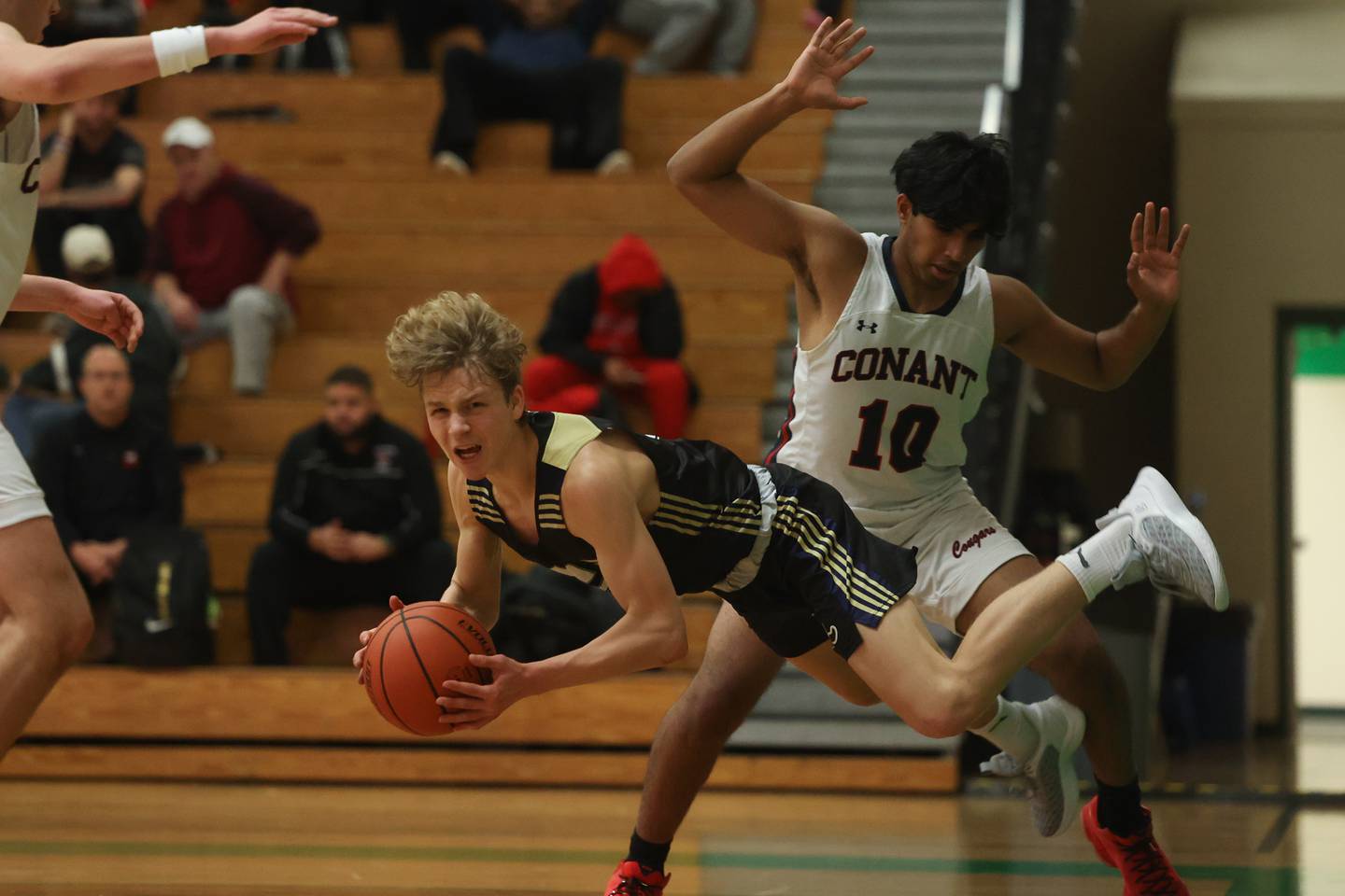 Lemont’s Rokas Castillo goes airborne on a foul by Conant’s Shreyas Talluri in the Jack Tosh Holiday Classic at York High School on December 27th.