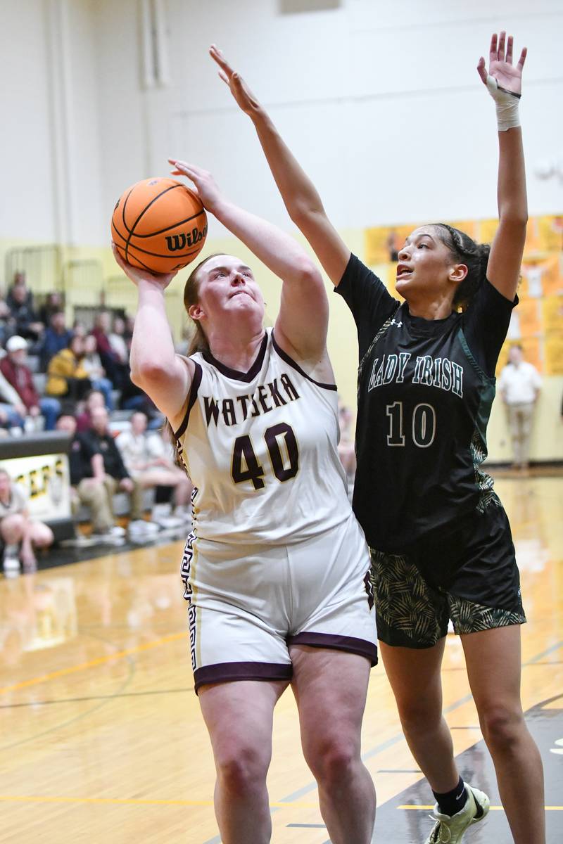Bishop McNamara's Trinitee Thompson defends a shot by Watseka-Milford's Megan Martin during the Fightin' Irish's 69-38 victory over Watseka-Milford in the IHSA Class 2A Herscher Sectional championship on Thursday, Feb. 27.