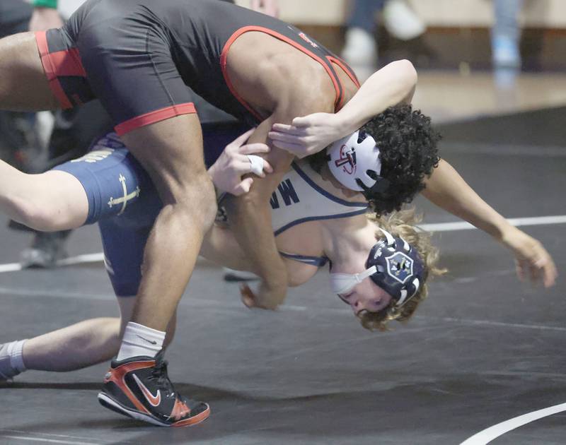 Marqutte's Logan Huenfield wrestles Bradley-Bourbonnias's Razi Perez on Wednesday, Jan. 14, 2026 in Bader Gymnasium at Marquette Academy.