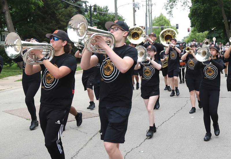 Members of the DeKalb High School marching band make the turn onto Linden Place from West Locust Street during the DeKalb Memorial Day parade Monday, May 27, 2024, as they make their way to Ellwood House.