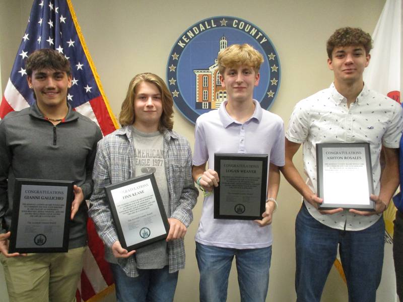 Yorkville High School students Gianni Gallichio, from left, Finn Keane, Logan Weaver and Ashton Rosales were honored  by the Kendall County Board on Nov. 1, 2022 for saving the life of a 4-year-old boy who nearly died of drowning at a local swimming pool.