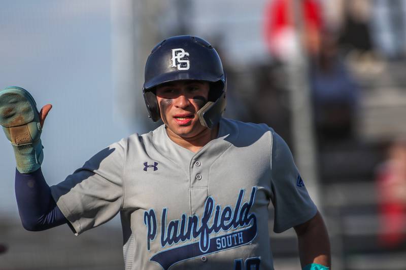Plainfield South's Pablo Herrera (10) runs into the dugout after scoring a run during baseball game between Plainfield South at Oswego on Monday, April 14, 2025 in Oswego.