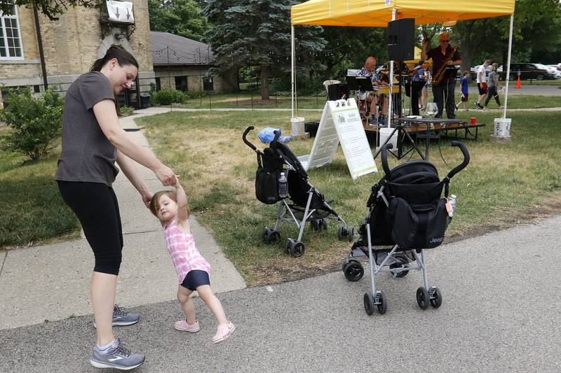 Laura Sanford of Crystal Lake dances with her daughter Ava, 2, to the music of Twang Shui performing live at the farmers market outside the Dole Mansion on Sunday, June 20, 2021, in Crystal Lake.  The farmers market is new to the Dole this year, having never had one there before this month.