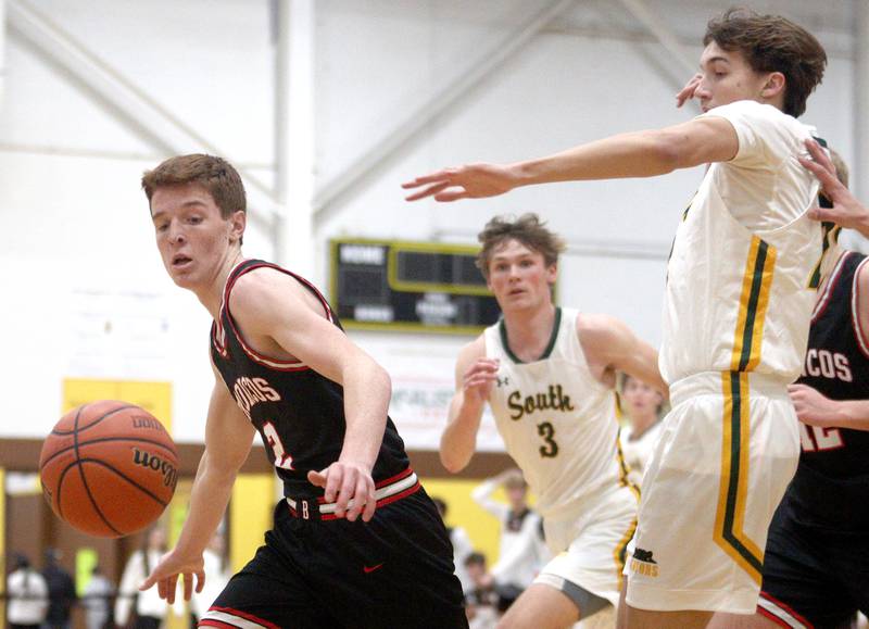 Crystal Lake South’s  Tony Santarelli, right, and Barrington’s Adam Baird, left, follow the ball in Hinkle Holiday Classic boys basketball tournament game action at Jacobs High School Tuesday.