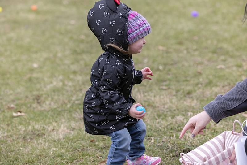 Emma Dewey, 3, of Amboy gets help from mom Keri Spinelli while picking up eggs in Rock Falls Saturday, April 1, 2023.