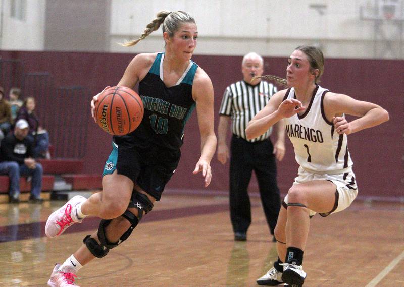 Marengo’s Emily Kirchhoff, right, guards Woodstock North’s Addison Rishling in varsity girls basketball at Marengo Tuesday evening.