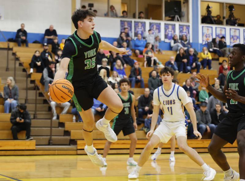 York's Miles Burnison (35) saves a ball headed out of bounds during a varsity basketball game between York Community and Lyons Township high schools on Friday, Jan. 9, 2026 in La Grange.