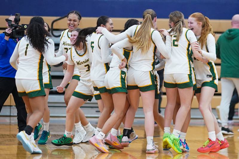 Waubonsie Valley basketball players celebrate after defeating Bent in overtime to win the Class 4A Oswego Sectional final at Oswego High School on Thursday, Feb 22, 2024.