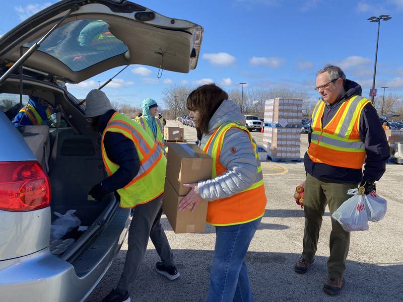 Volunteers oack boxes to be distributed to area food pantries from Northern Illinois Food Bank. The bank expects to service thousands this holiday season, noting the need to address food insecurity is higher than numbers recorded during the COVID-19 pandemic.