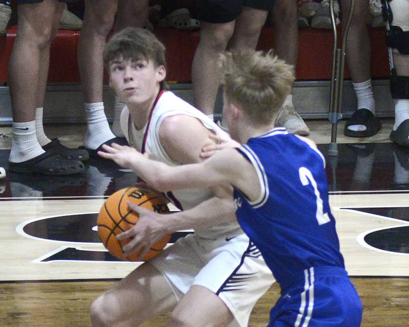 Woodland’s Nate Berry eyes the basket while trying to get past Newark’s Kellen Westerfield in the 3rd period Friday at the Woodland Regional.