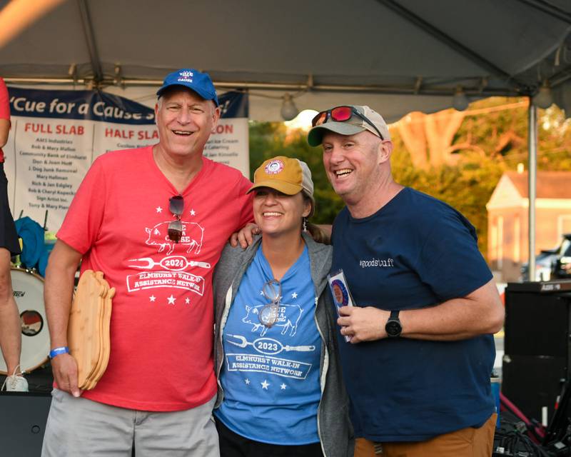 Andy Crnkowich, left, poses with Bill and Michelle Steber from Sweet William’s sauce from Villa Park smile as they receive their award from the people’s choice award for their Sause on Sunday Sep. 1, 2024, held in downtown Elmhurst.