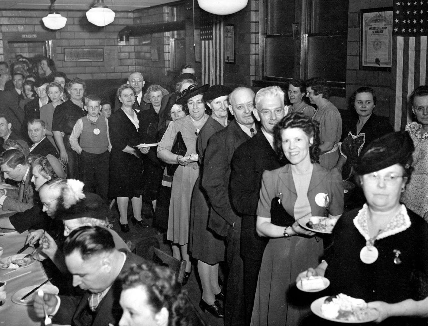 Taken during World War II, this was an E-Award dinner for Woodstock Typewriter employees. Elmer Broderman is identified.