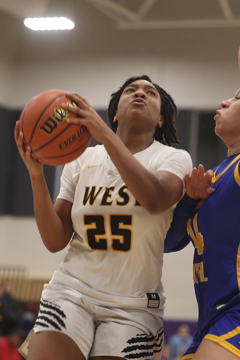 Joliet West’s Mariah Shelton goes in for the shot against Joliet Central at Joliet Junior College.