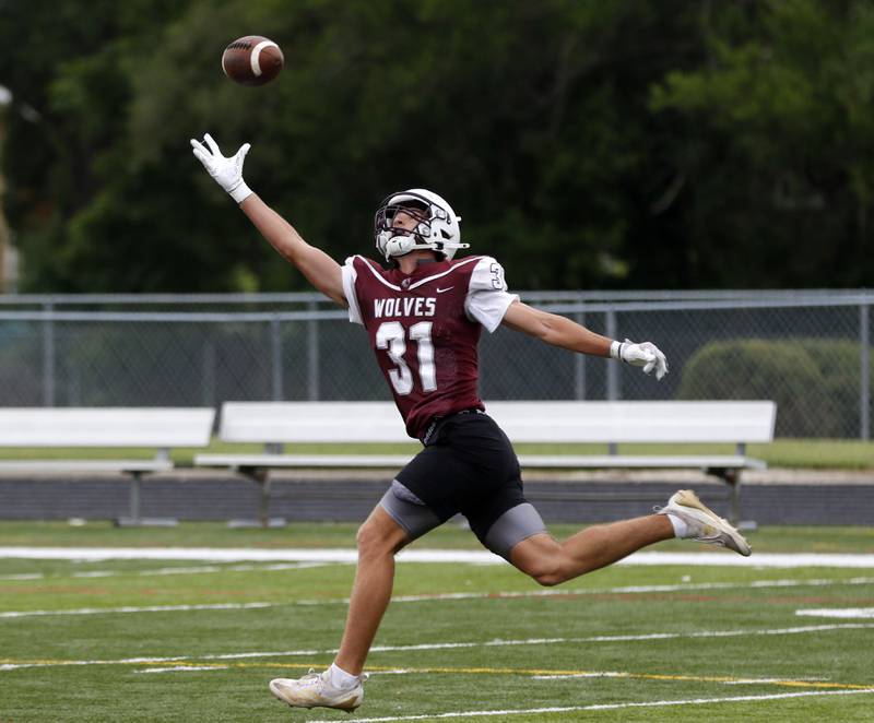 Prairie Ridge’s Logan Thennes reaches for pass during football practice against Grant on  Thursday, July 17, 2025, at Grant High School in Fox Lake.