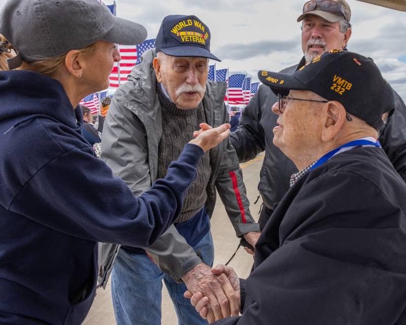 Edward Smith and Richard Kolodey, both World War 2 veterans exchange a handshake as they meet for the first time and share their military backgrounds during the 10th annual TBM Avenger Reunion and Airshow on Saturday, May 17, 2025 at the Illinois Valley Regional Airport in Peru.