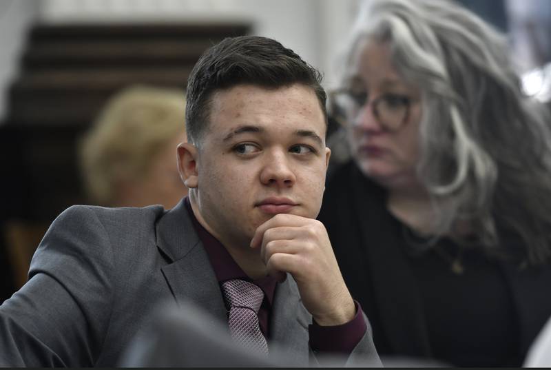 Kyle Rittenhouse sits with his attorneys after a lunch break and waits for proceedings to start at the Kenosha County Courthouse in Kenosha, Wis., on Tuesday, Nov. 9, 2021. Rittenhouse is accused of killing two people and wounding a third during a protest over police brutality in Kenosha, last year.  (Sean Krajacic/The Kenosha News via AP, Pool)