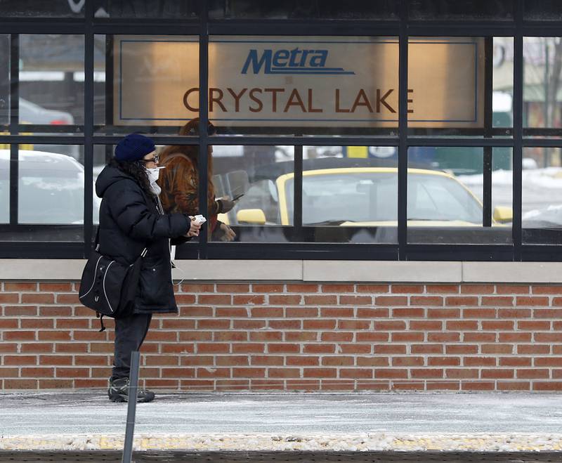 People wait for a train Thursday, Feb, 3, 2022, at the Metra station in downtown Crystal Lake. Crystal Lake and Cary are in the considering purchases their downtown stations after Union Pacific decided to sell this station and other commuter stations.
