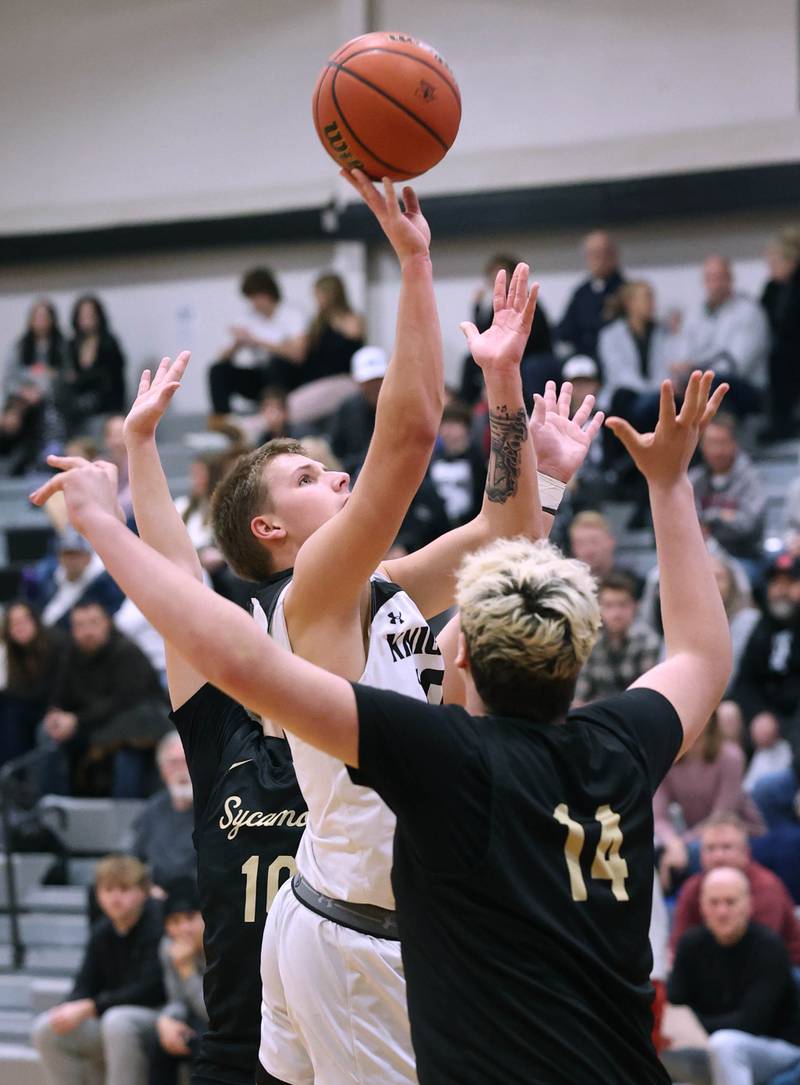 Kaneland's Troyer Carlson shoots over Sycamore's Michael Chami during their game Friday, Jan. 5, 2024, at Kaneland High School in Maple Park.