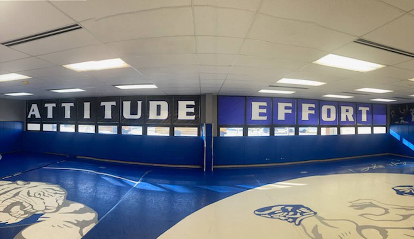 The windows of the PHS wrestling room spell out A-T-T-I-T-U-DE and E-F-F-O-R-T.
