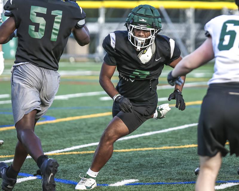 Jayden Daniel rushes from the end position at Glenbard West football practice, Wednesday, Aug 21, 2025  in Glen Ellyn.