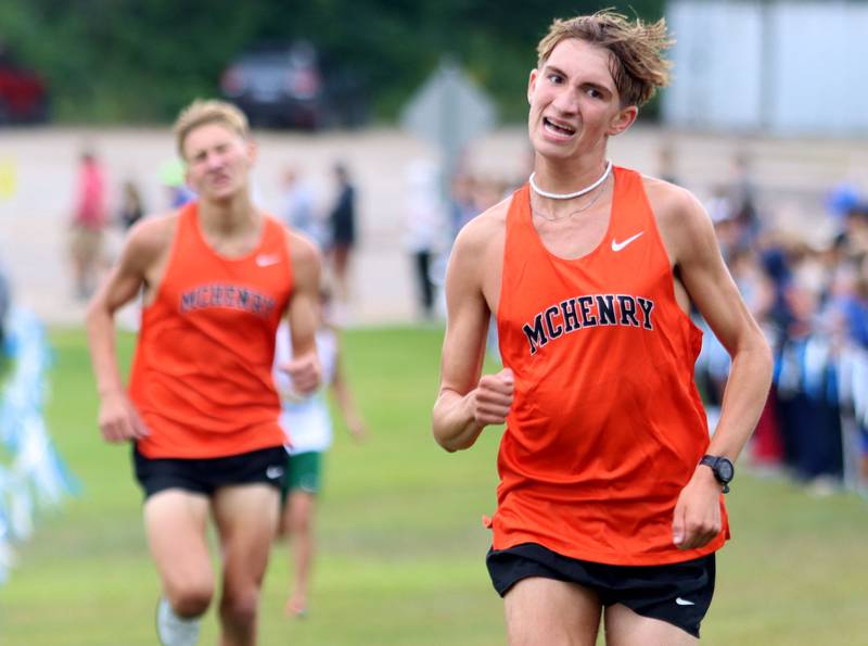 McHenry’s Nate Martin, right, and Myles Wagner finish the boys varsity race during the McHenry County Cross Country Meet at Emricson park in Woodstock on Saturday, August 30, 2025.