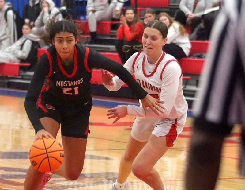 Huntley’s Evelyn Freundt, right, keeps up with Mundelein’s Anahya Castro in varsity girls basketball Komaromy Classic tournament  action on Tuesday, Dec. 30, 2025, at Dundee-Crown High School in Carpentersville.