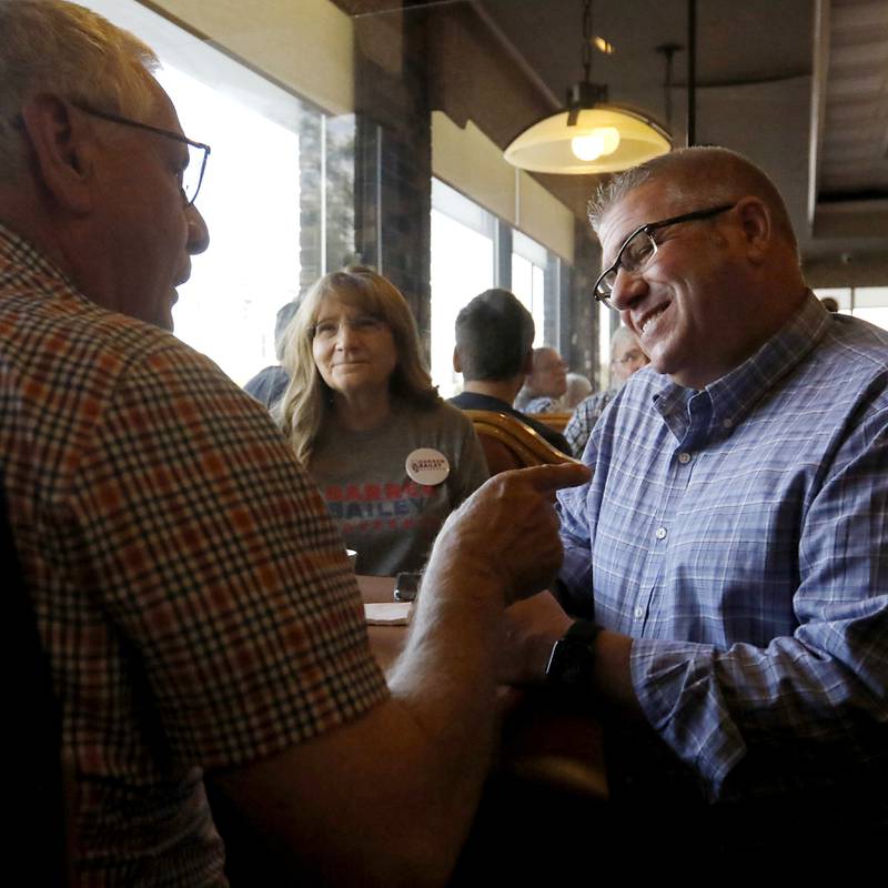 David MacPhail, left, of Wauconda, talks with Republican candidate for governor Darren Bailey as Bailey campaigns Wednesday, Sept. 21, 2022, at the Around the Clock Restaurant, 5011 Northwest Highway, in Crystal Lake, during a nine-city bus tour, with his Lt. Governor candidate Stephanie Trussell.