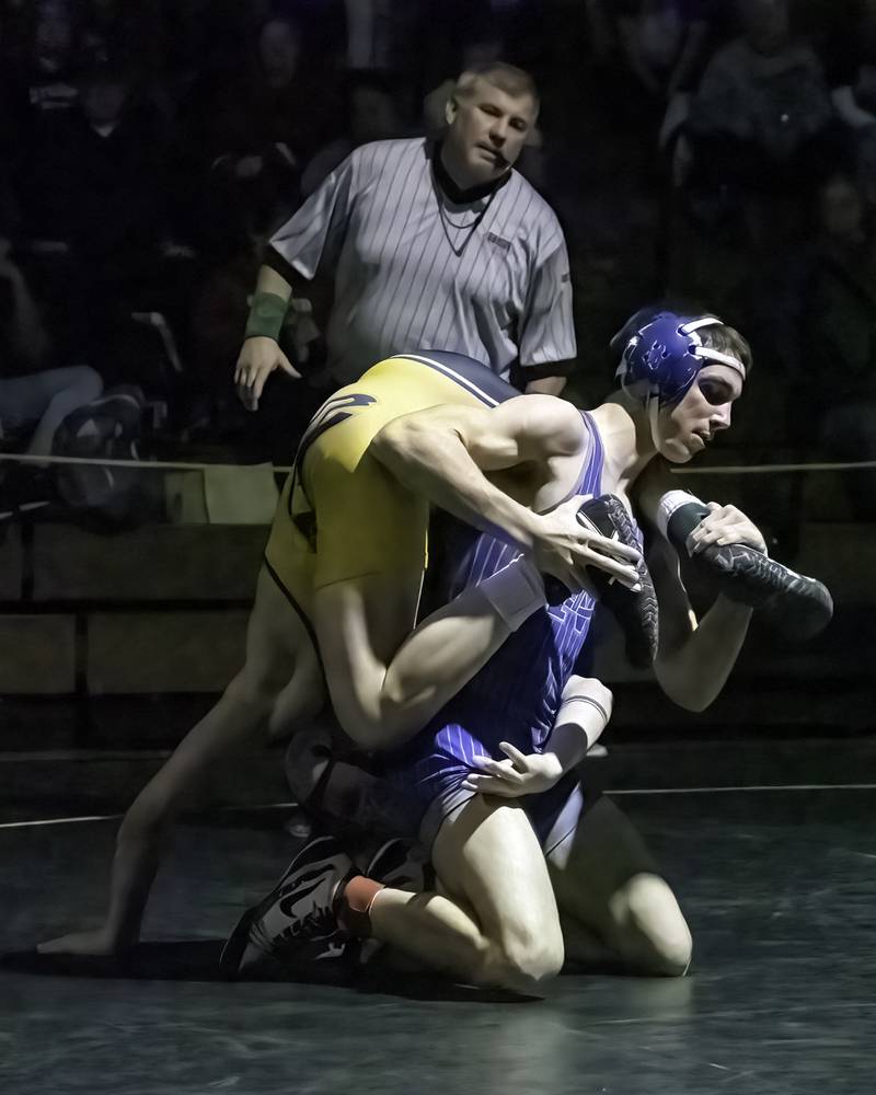 Newman's Carter Rude (right) flips over Riverdale's Brock Smith during the 138-pound title bout at the 1A Riverdale Regional on Saturday, Feb. 4, 2023.