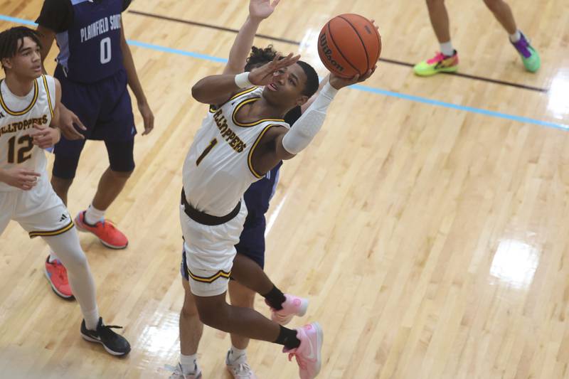 Joliet Catholic’s Jayden Armstrong draws the foul going for the basket against Plainfield South on Wednesday, Jan. 17th, 2024 in Joliet.