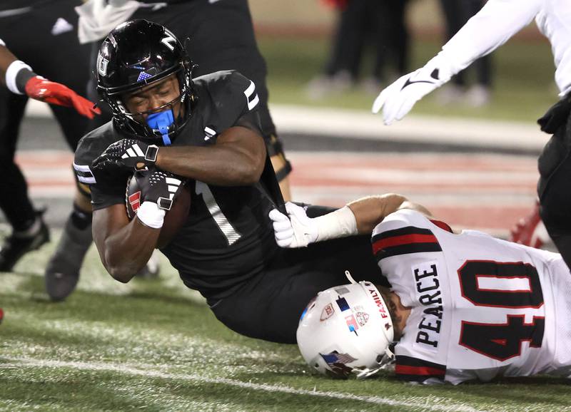 Northern Illinois' Antario Brown is brought down by Ball State's Cole Pearce during their game Tuesday, Nov. 7, 2023, in Huskie Stadium at NIU in DeKalb.