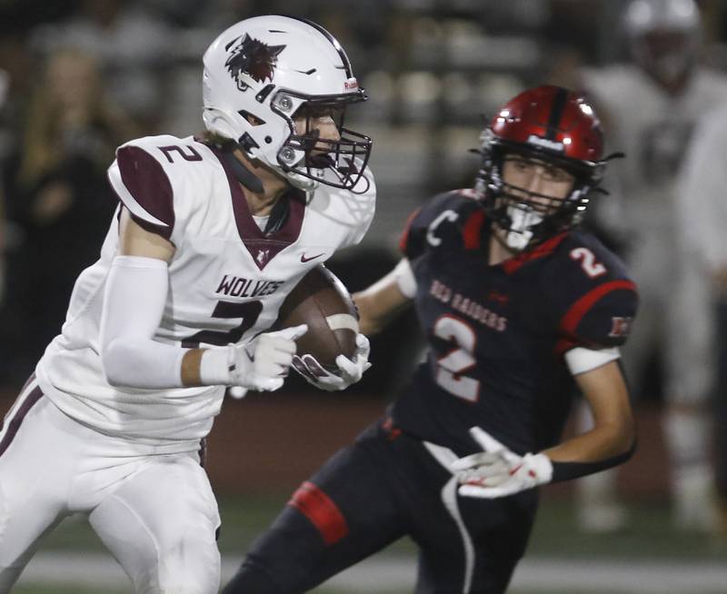 Prairie Ridge's Logan Thennes runs around the pursuit of Huntley's Colin Masten during a Fox Valley Conference football game on Friday, Sept. 20, 2024, at Huntley High School.