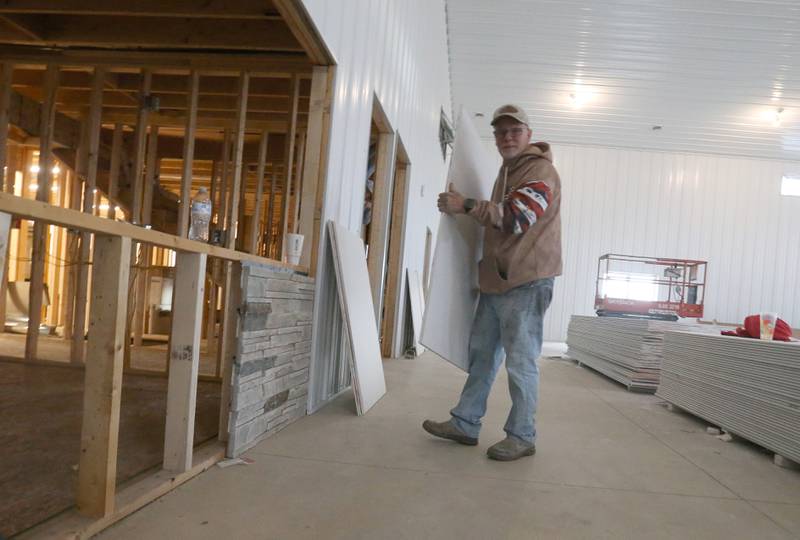 Jeff VanAutreve moves a piece of dry wall inside the Second Story Teen Center on Wednesday, Dec. 12, 2024 in Princeton. Construction is coming along quite nicely. Work is expected to be completed in the Spring of 2025. The center is $250,000 short of completing the project. They are asking the community for donations. Every week, Second Story Teen Center provides meals, mentorship, and a safe place for approximately 150 teens to gather, grow, and thrive. Over the years, the center has been instrumental in fostering positive change in the community, contributing to a decline in teen suicide rates and teen theft.