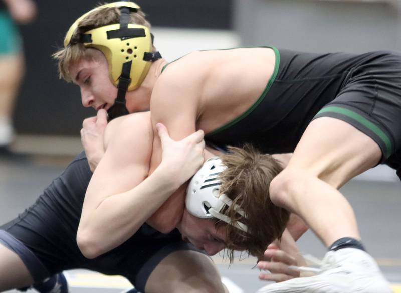 Crystal Lake South’s Logan Aarseth, top, battles Marian’s Hogan Rice at 113 pounds in boys wrestling IHSA Class 2A Regional championship bout action on Saturday, Jan. 31, 2026, at Harvard High School in Harvard.
