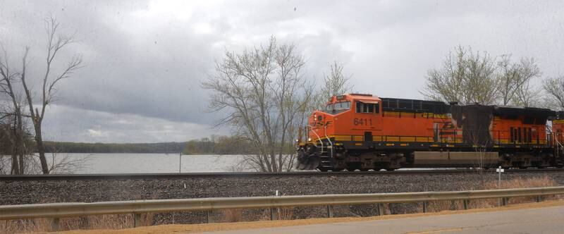 A Burlington Northern-Santa Fe freight train speeds down the track along the Mississippi River north of Savanna on Saturday, April 22.