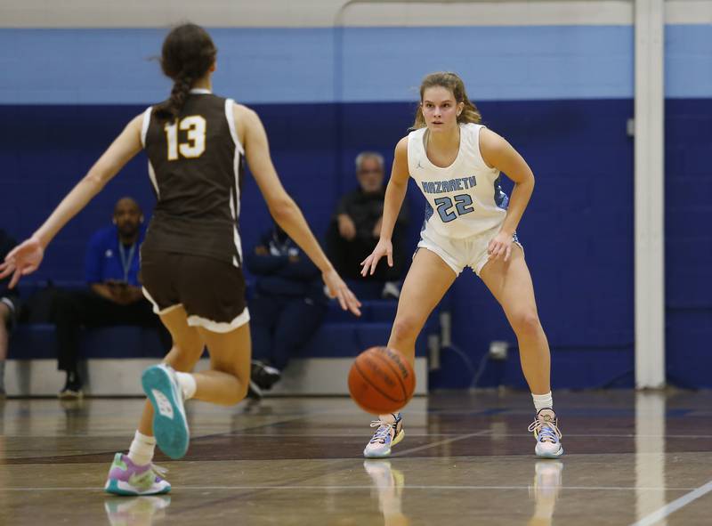 Nazareth's Gracie Carstensen (22) waits back on defense during the girls varsity basketball game between Carmel High School and Nazareth Academy on Wednesday, Dec. 7, 2022 in LaGrange, IL.