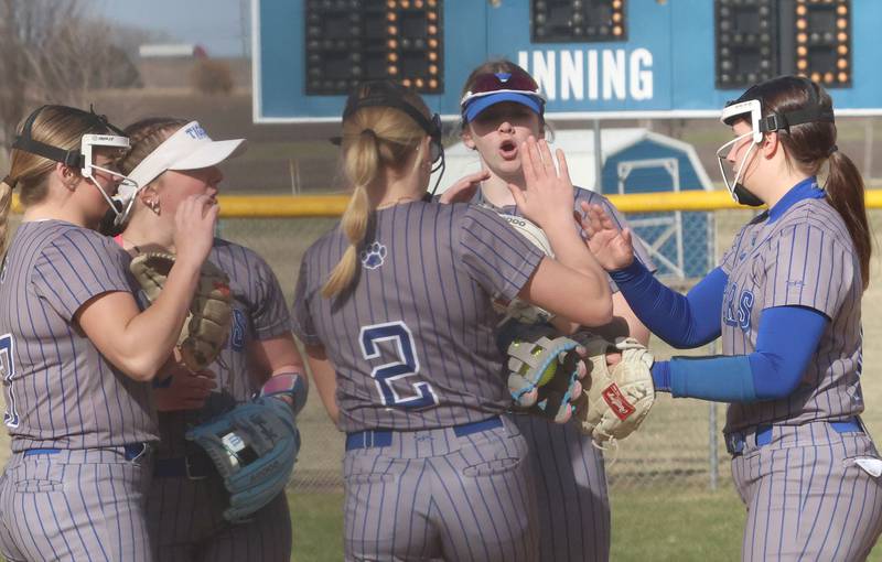 Members of the Princeton softball team meet on the mound between innings while playing L-P on Tuesday, March 24, 2026 at Little Sibera Field in Princeton.
