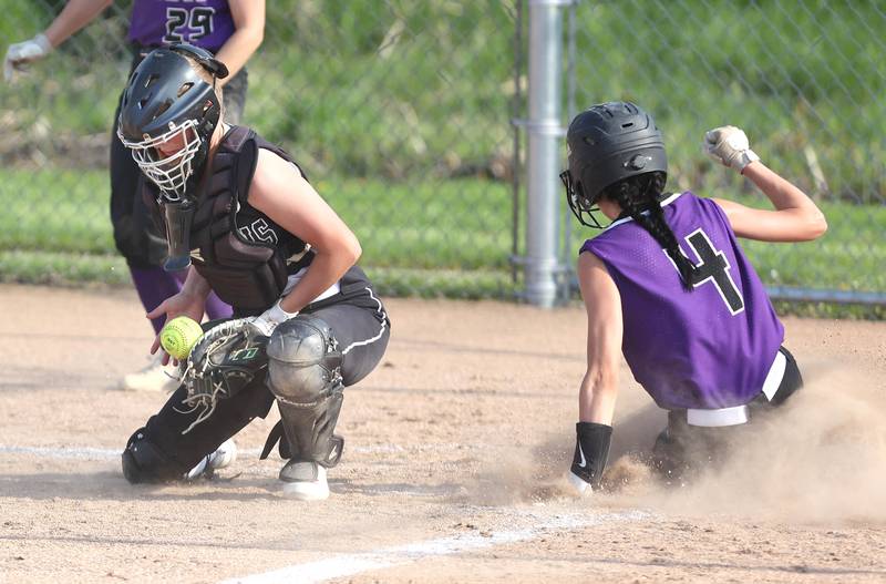 Sycamore's Haley Von Schnase blocks the late throw as Dixon's Arianne Smith scores during their game Thursday, May 12, 2022, at Sycamore High School.