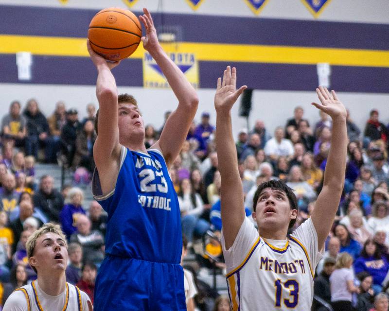 Newman's John Rowzee (23) lays ball up as Oliver Munoz (13) of Mendota attempts to contest shot on Friday, January 30, 2026 at Mendota High School in Mendota.