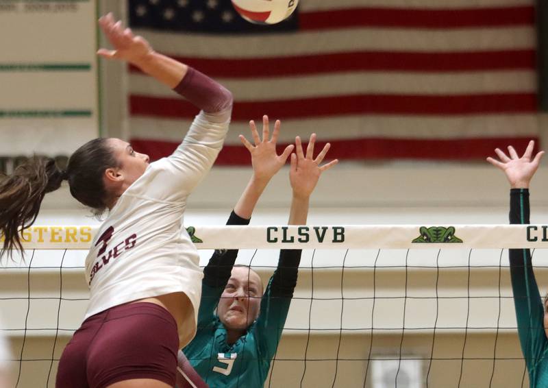 Prairie Ridge’s Maizy Agnello prepares to hammer the ball as Woodstock North’s Clara Klasek blocks in IHSA Class 3A Sectional semifinal volleyball action on Tuesday, Nov. 5, 2024, at  Crystal Lake South High School  in Crystal Lake.