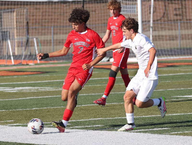 Yorkville's Oliver Villa tries to hold off Sycamore's Chase Reyman Thursday, Aug. 28, 2025, during their game in the Barb Cup tournament at DeKalb High School.