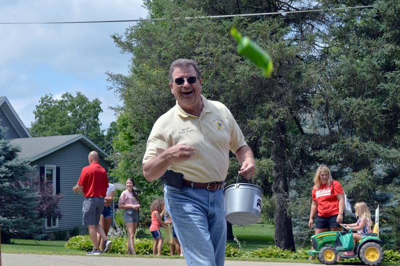 Stephenson County Sheriff David Snyders grins as he tosses a piece of candy to German Valley Days parade attendees on July 16.